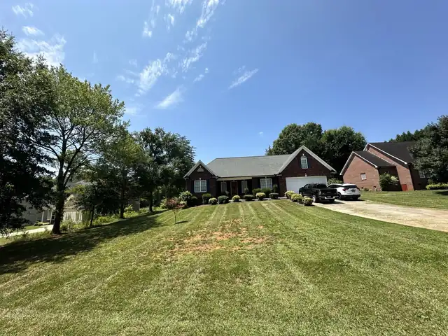 Freshly mowed striped lawn on a Tiny Trail Landscaping job