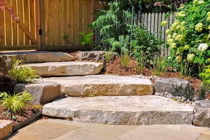 Large natural stone slab steps in a front garden